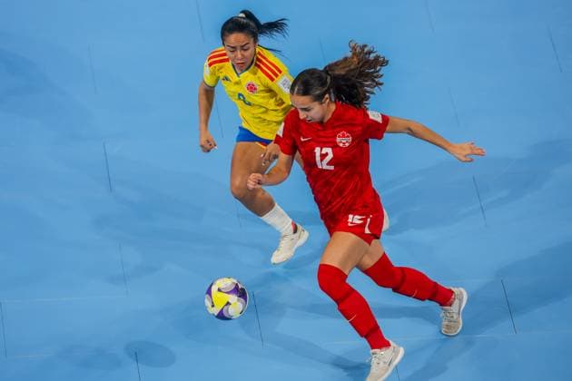 (251122) -- PASIG CITY, Nov. 22, 2025 -- Magali Gagne (R) of Canada vies against Alejandra Apraez of Colombia during the match between Colombia and Canada at the FIFA Futsal Women s World Cup 2025 in Pasig City, the Philippines, Nov. 22, 2025. ) (SP)PHILIPPINES-PASIG CITY-FUTSAL-WOMEN S WORLD CUP 2025-COLOMBIA VS CANADA RouellexUmali 