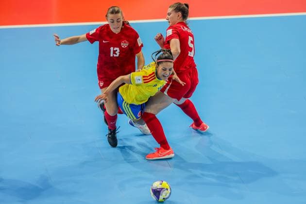 (251122) -- PASIG CITY, Nov. 22, 2025 -- Diana Celis (C) of Colombia vies against Katerine Delev (L) and Maude Lagace (R) of Canada during the match between Colombia and Canada at the FIFA Futsal Women s World Cup 2025 in Pasig City, the Philippines, Nov. 22, 2025. ) (SP)PHILIPPINES-PASIG CITY-FUTSAL-WOMEN S WORLD CUP 2025-COLOMBIA VS CANADA RouellexUmali 
