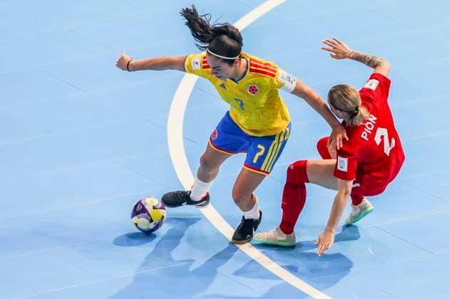(251122) -- PASIG CITY, Nov. 22, 2025 -- Merlin Salcedo (L) of Colombia competes against Erika Pion (R) of Canada during the match between Colombia and Canada at the FIFA Futsal Women s World Cup 2025 in Pasig City, the Philippines, Nov. 22, 2025. ) (SP)PHILIPPINES-PASIG CITY-FUTSAL-WOMEN S WORLD CUP 2025-COLOMBIA VS CANADA RouellexUmali 