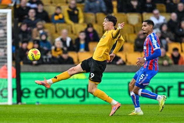 22nd November 2025; Molineux Stadium, Wolverhampton, West Midlands, England; Premier League Football, Wolverhampton Wanderers versus Crystal Palace; Jorgen Strand Larsen of Wolverhampton Wanderers stretches to control the ball watched Maxence Lacroix of Crystal Palace  GodfreyxPitt