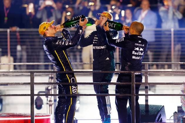 LAS VEGAS, NV - NOVEMBER 22: Race winner Max Verstappen, driver of the 1 Red Bull Racing (left), George Russell, driver of the 63 Mercedes (center) and Red Bull engineer Gianpiero Lambiase celebrate by drinking Moet champagne after the Formula 1 Las Vegas Grand Prix on November 22, 2025 on the Las Vegas Strip Circuit in Las Vegas, Nevada.(Photo by Jeff Speer Icon Sportswire) AUTO: NOV 22 F1 Las Vegas Grand Prix EDITORIAL USE ONLY Icon2511220681