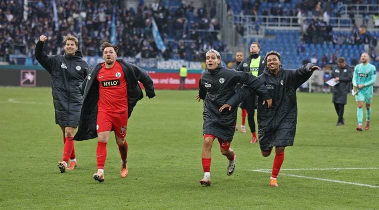 23.11.2025, Fussball, Herren, 2. Bundesliga, Saison 2025 2026, Karlsruher SC - SV 07 Elversberg, Die Spieler der SV 07 Elversberg rennen nach dem Spiel in die Fankurve und feiern mit den Fans den Sieg, Maximilian Rohr (SV 07 Elversberg), Luca Schnellbacher (SV 07 Elversberg), Frederik Schmahl (SV 07 Elversberg) und Bambase Conte (SV 07 Elversberg) Karlsruhe BBBank Wildpark Baden-Württemberg Deutschland (DEU) Copyright: xFabianxKleerx