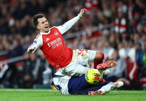 Martin Zubimendi of Arsenal is fouled by Djed Spence of Tottenham Hotspur Arsenal v Tottenham Hotspur, Premier League, Football, Emirates Stadium, London, UK - 23 Nov 2025London Emirates Stadium United Kingdom EDITORIAL USE ONLY No use with unauthorised audio, video, data, fixture lists, club league logos or live services. Online in-match use limited to 120 images, no video emulation. No use in betting, games or single club league player publications. Copyright: xMichaelxZemanek Shutterstockx 15860967aw