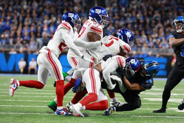 New York Giants vs Detroit Lions DETROIT,MICHIGAN-NOVEMBER 23: New York Giants safety Jevon Holland 8 is tackled by Detroit Lions wide receiver Amon-Ra St. Brown 14 during the second half of an NFL, American Football Herren, USA football game between the New York Giants and the Detroit Lions in Detroit, Michigan USA, on Sunday, November 23, 2025 Detroit Michigan United States  Copyright: xJorgexLemusx originalFilename:lemus-newyorkg251123_npBTb.jpg