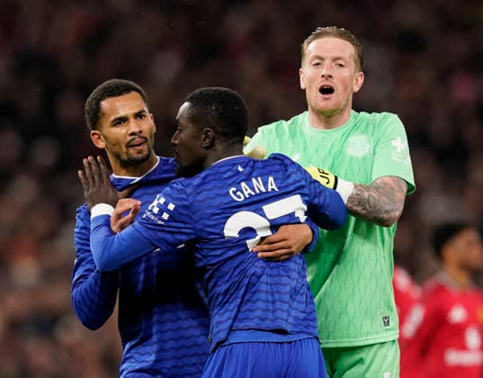 Manchester, England, 24th November 2025. Jordan Pickford of Everton (r) and Iliman Ndiaye of Everton (l) holds back red carded Idrissa Gueye of Everton (c) following a clash with Michael Keane of Everton during the Manchester United, ManU vs Everton Premier League match at Old Trafford, Manchester. Picture credit should read: Andrew Yates Sportimage EDITORIAL USE ONLY. No use with unauthorised audio, video, data, fixture lists, club league logos or live services. Online in-match use limited to 120 images, no video emulation. No use in betting, games or single club league player publications. SPI_042_AY_Manchester_Utd_Everton SPI-4308-0041