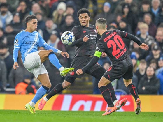 Manchester City v Bayer Leverkusen UEFA Champions League Rico Lewis of Manchester City and Alex Grimaldo of Bayer Leverkusen battles for the ball during the UEFA Champions League match at the Etihad Stadium, Manchester UK Newspapers OUT Copyright: xKarlxVallantinex FIL-22550-0035