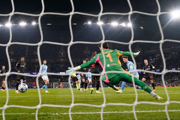 Manchester, England, 25th November 2025. Alex Grimaldo of Bayer Leverkusen (r) scores the first goal during the Manchester City vs Bayer Leverkusen UEFA Champions League match at the Etihad Stadium, Manchester. Picture credit should read: Andrew Yates Sportimage EDITORIAL USE ONLY. No use with unauthorised audio, video, data, fixture lists, club league logos or live services. Online in-match use limited to 120 images, no video emulation. No use in betting, games or single club league player publications. SPI_050_AY_Man_City_Leverkusen SPI-4309-0069