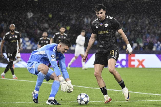 Napoli v Qarabag - UEFA Champions League NAPOLI, ITALY - NOVEMBER 25: Mateusz Kochalski (L), goalkeeper of Qarabag, flanked by his teammate Bahlul Mustafazade (R), takes the ball during the League phase UEFA Champions League football match between Napoli and Qarabag at the Diego Armando Maradona stadium in Naples, Italy, on November 25, 2025. Isabella Bonotto Anadolu Napoli Italy. Editorial use only. Please get in touch for any other usage.  Copyright: x2025xAnadoluxIsabellaxBonottox