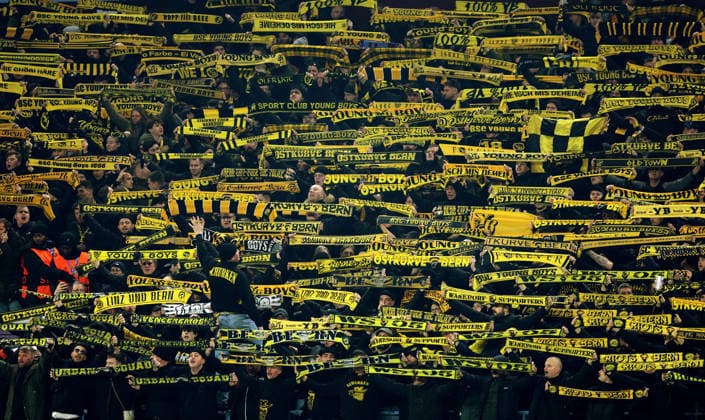 Birmingham, England, 27th November 2025. Young Boys fans hold up their scarves during the Aston Villa vs Young Boys UEFA Europa League match at Villa Park, Birmingham. Picture credit should read: James Baylis Sportimage EDITORIAL USE ONLY. No use with unauthorised audio, video, data, fixture lists, club league logos or live services. Online in-match use limited to 120 images, no video emulation. No use in betting, games or single club league player publications. SPI_008_JB_Villa_YoungBoys SPI-4329-0008
