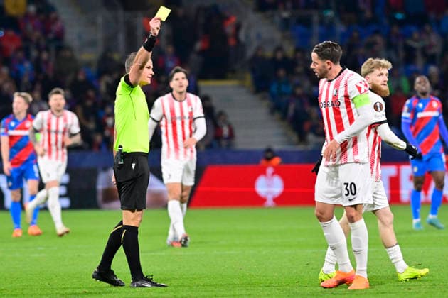 Referee Morten Krogh gives a yellow card to Christian Gunter (Freiburg) in the Football Europa League, 5th round match: FC Viktoria Plzen vs SC Freiburg in Pilsen, Czech Republic, November 27, 2025. (CTKxPhoto MiroslavxChaloupka) CTKPhotoP2025112708140  CTKPhotoP2025112708140
