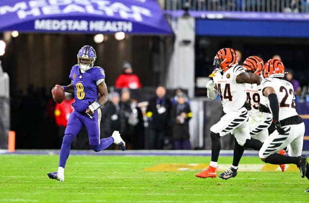 Baltimore Ravens quarterback Lamar Jackson (8) scrambles for a first down ahead of Cincinnati Bengals linebacker Demetrius Knight Jr. (44), linebacker Barrett Carter (49), and safety Geno Stone (22) during the second quarter at M&T Bank Stadium in Baltimore, Maryland, on Thursday, November 27 2025.  BAL20251127140 DAVIDxTULIS