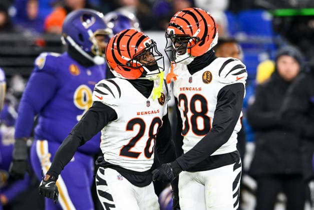 Cincinnati Bengals cornerbacks Josh Newton (28) and D.J. Ivey (38) celebrate blocking an attempted pass to Baltimore Ravens wide receiver Zay Flowers during the fourth quarter at M&T Bank Stadium in Baltimore, Maryland, on Thursday, November 27 2025. Cincinnati won 32-14.  BAL20251127146 DAVIDxTULIS