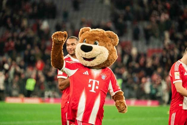 Deutschland, Fußball, 1. Bundesliga 2025 26, 12. Spieltag - FC Bayern München gegen FC St. Pauli - Allianz Arena München: FC Bayern Maskottchen Berni nach dem Abpfiff beim Feiern mit den Fans Copyright: xJamesxZabelx