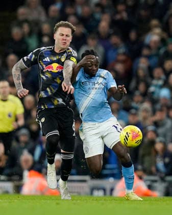 Manchester, England, 29th November 2025. Joe Rodon of Leeds United (L) challenges Jeremy Doku of Manchester City during the Manchester City vs Leeds United Premier League match at the Etihad Stadium, Manchester. Picture credit should read: Andrew Yates Sportimage EDITORIAL USE ONLY. No use with unauthorised audio, video, data, fixture lists, club league logos or live services. Online in-match use limited to 120 images, no video emulation. No use in betting, games or single club league player publications. SPI_029_AY_MAN_CITY_LEEDS SPI-4333-0029