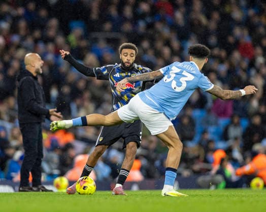29th November 2025; Etihad Stadium, Manchester, Lancashire, England; Premier League Football, Manchester City versus Leeds United; Jayden Bogle of Leeds United is tackled by Nico O Reilly of Manchester City  TimxWilliams