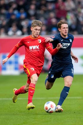 v.li.: Anton Kade (FCA, 30), Wouter Burger (Hoffenheim, 18), Zweikampf, Spielszene, Duell, duel, tackle, tackling, Dynamik, Action, Aktion, 29.11.2025, Sinsheim (Deutschland), Fussball, Bundesliga, TSG 1899 Hoffenheim - FC Augsburg, DFB DFL REGULATIONS PROHIBIT ANY USE OF PHOTOGRAPHS AS IMAGE SEQUENCES AND OR QUASI-VIDEO.