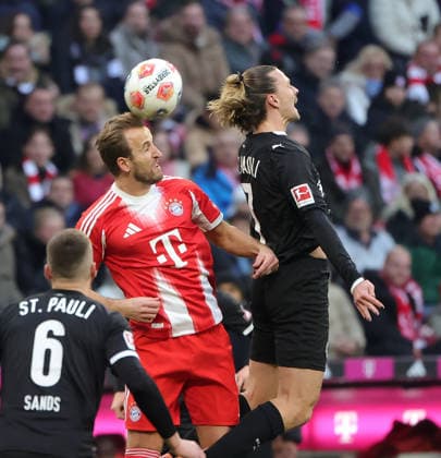 (251130) -- MUNICH, Nov. 30, 2025 -- Harry Kane (C) of FC Bayern Munich and Jackson Irvine (R) of FC St. Pauli head for the ball during the German first division Bundesliga football match between FC Bayern Munich and FC St. Pauli in Munich, Germany, Nov. 29, 2025. (Photo by Xinhua) (SP)GERMANY-MUNICH-FOOTBALL-BUNDESLIGA-BAYERN MUNICH VS ST. PAULI PhilippexRuiz 