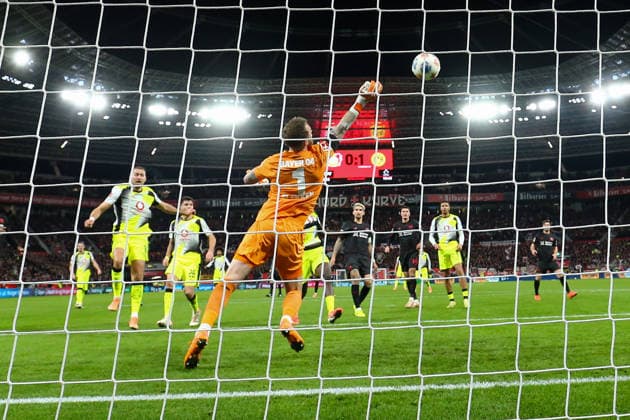 (251130) -- LEVERKUSEN, Nov. 30, 2025 -- Mark Flekken (front), goalkeeper of Bayer 04 Leverkusen, makes a save during the German first division of Bundesliga football match between Bayer 04 Leverkusen and Borussia Dortmund in Leverkusen, Germany, Nov. 29. 2025. (Photo by Xinhua) (SP)GERMANY-LEVERKUSEN-FOOTBALL-BUNDESLIGA-LEVERKUSEN VS DORTMUND JoachimxBywaletz 
