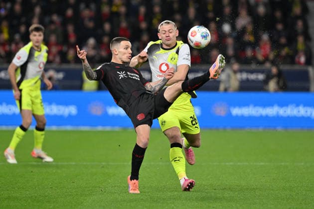 Alejandro Grimaldo (Bayer 04 Leverkusen), Julian Ryerson (Borussia Dortmund), v.li. 29.11.2025, Fussball 1. Bundesliga, Saison 2025 2026, 12. Spieltag, Bayer 04 Leverkusen - Borussia Dortmund 1:2 DFL regulations prohibit any use of photographs as image sequences and or quasi-video Leverkusen BayArena Nordrhein Westfalen Deutschland