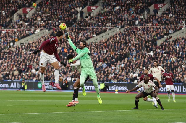 30th November 2025; London Stadium, London, England; Premier League Football, West Ham United versus Liverpool; goalkeeper Alisson Becker of Liverpool punches an incoming cross clear while colliding with Joe Gomez resulting in the match being stopped and physios coming on for treatment  KatiexChan