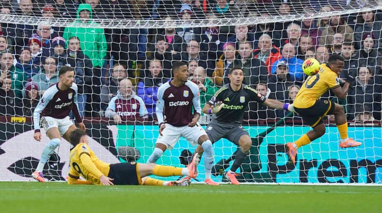 Birmingham, England, 30th November 2025. Jorgen Strand Larsen of Wolverhampton Wanderers scores but it is ruled out for Matheus Cunha of Wolverhampton Wanderers (r) impending the goalkeeper during the Aston Villa vs Wolverhampton Wanderers Premier League match at Villa Park, Birmingham. Picture credit should read: Andrew Yates Sportimage EDITORIAL USE ONLY. No use with unauthorised audio, video, data, fixture lists, club league logos or live services. Online in-match use limited to 120 images, no video emulation. No use in betting, games or single club league player publications. SPI_017_AY_Villa_Wolves SPI-4336-0017