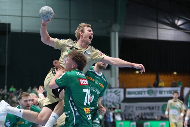 Handball DAIKIN HBL, SC DHfK Leipzig - TSV Hannover-Burgdorf; 30.11.2025 Marian Michalczik (22, Hannover-Burgdorf) prallt im Wurf gegen Tom Koschek (76, SC DHfK Leipzig). Handball, DAIKIN HBL, 1. Bundesliga, Saison 2025 2026, 14. Spieltag: SC DHfK Leipzig vs. TSV Hannover-Burgdorf am 30.11.2025 in der Quarterback Immobilien Arena Leipzig. Copyright: xBEAUTIFULxSPORTS JanxKaeferx