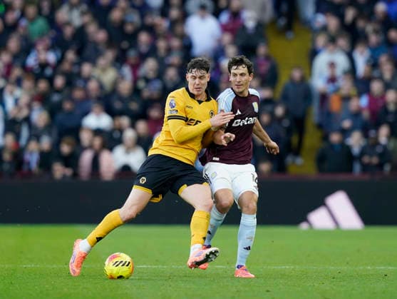 Birmingham, England, 30th November 2025. Jorgen Strand Larsen of Wolverhampton Wanderers (l) tussles with Pau Torres of Aston Villa (r) during the Aston Villa vs Wolverhampton Wanderers Premier League match at Villa Park, Birmingham. Picture credit should read: Andrew Yates Sportimage EDITORIAL USE ONLY. No use with unauthorised audio, video, data, fixture lists, club league logos or live services. Online in-match use limited to 120 images, no video emulation. No use in betting, games or single club league player publications. SPI_024_AY_Villa_Wolves SPI-4336-0024