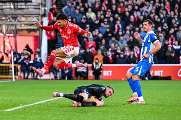 30th November 2025; The City Ground, Nottingham, England; Premier League Football, Nottingham Forest versus Brighton and Hove Albion; Bart Verbruggen of Brighton claims the ball at the feet of Morgan Gibbs-White of Nottingham Forest as Lewis Dunk of Brighton watches on  GodfreyxPitt