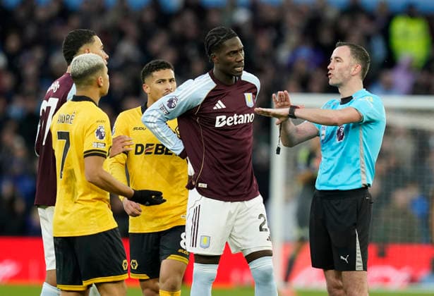 Birmingham, England, 30th November 2025. Referee Christopher Kavanagah (r) rules out a red card for Jhon Arias of Wolverhampton Wanderers following a VAR review during the Aston Villa vs Wolverhampton Wanderers Premier League match at Villa Park, Birmingham. Picture credit should read: Andrew Yates Sportimage EDITORIAL USE ONLY. No use with unauthorised audio, video, data, fixture lists, club league logos or live services. Online in-match use limited to 120 images, no video emulation. No use in betting, games or single club league player publications. SPI_039_AY_Villa_Wolves SPI-4336-0039