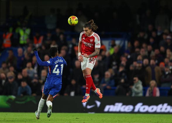 30th November 2025; Stamford Bridge, Chelsea, London, England: Premier League Football, Chelsea versus Arsenal; Riccardo Calafiori of Arsenal heads the ball over Estevao of Chelsea  JohnxPatrickxFletcher