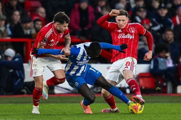 Nottingham, England, 30th November 2025. Yankuba Minteh of Brighton battles for the ball with Neco Williams and Elliot Anderson of Nottingham Forest during the Nottingham Forest vs Brighton and Hove Albion Premier League match at the City Ground, Nottingham. Picture credit should read: Craig Thomas Sportimage EDITORIAL USE ONLY. No use with unauthorised audio, video, data, fixture lists, club league logos or live services. Online in-match use limited to 120 images, no video emulation. No use in betting, games or single club league player publications. Z92_2479 SPI-4337-0140
