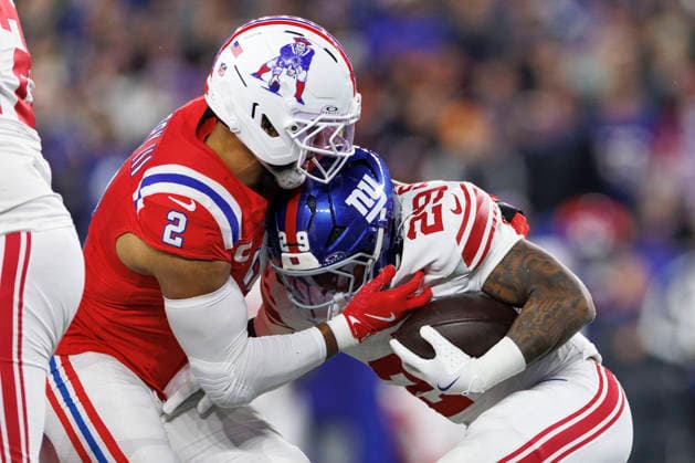 New England Patriots linebacker Harold Landry III (L) tackles New York Giants running back Tyrone Tracy Jr. (R) during the first half at Gillette Stadium in Foxborough, Massachusetts on Monday, December 01, 2025.  BOP20251201012 CJxGUNTHER