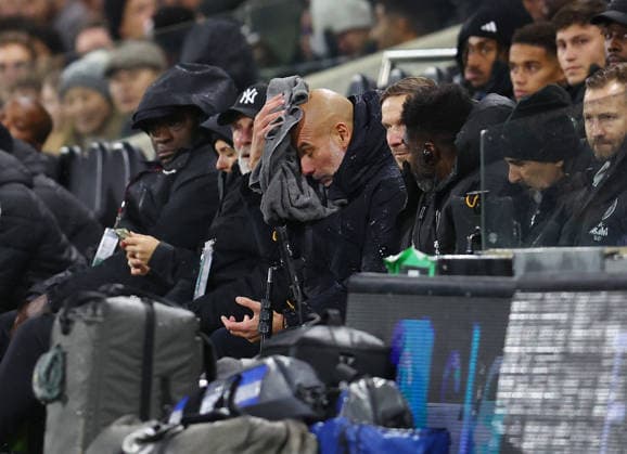 London, England, 2nd December 2025. Pep Guardiola coach of Manchester City wipes his face in the rain during the Fulham vs Manchester City Premier League match at Craven Cottage, London. Picture credit should read: Nigel Roddis Sportimage EDITORIAL USE ONLY. No use with unauthorised audio, video, data, fixture lists, club league logos or live services. Online in-match use limited to 120 images, no video emulation. No use in betting, games or single club league player publications. SPI_021_PT_Fulham_Man_City SPI-4339-0021