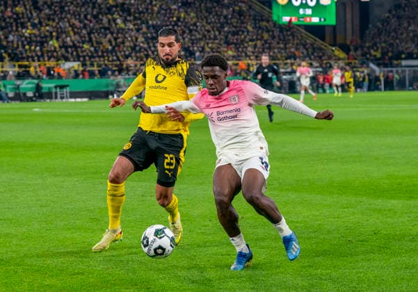 Zweikampf zwischen: duel between: Emre CAN (Borussia Dortmund, 23) and Ernest POKU (Bayer 04 Leverkusen, 19) Borussia Dortmund - Bayer Leverkusen, DFB Pokal Achtelfinale (Round of 16) in Dortmund, Signal Iduna Park DFL regulations prohibit any use of photographs as image sequences and or quasi-video. Copyright: HMBxMedia xMarcoxBader