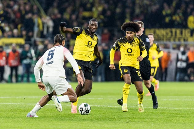 DORTMUND, GERMANY - DECEMBER 2: Serhou Guirassy (Borussia Dortmund, 9) and Karim Adeyemi (Borussia Dortmund, 27) battle for the ball against Loic Bade (Bayer 04 Leverkusen, 5) during the DFB Pokal Round of 16 match between Borussia Dortmund vs. Bayer 04 Leverkusen at Signal Iduna Park on Round of Sixteen of the DFB Pokal on December 2, 2025 in Dortmund, Germany. DFB REGULATIONS PROHIBIT ANY USE OF PHOTOGRAPHS AS IMAGE SEQUENCES AND OR QUASI-VIDEO. North Rhine Westphalia Germany Copyright: xBEAUTIFULxSPORTS Wunderlx