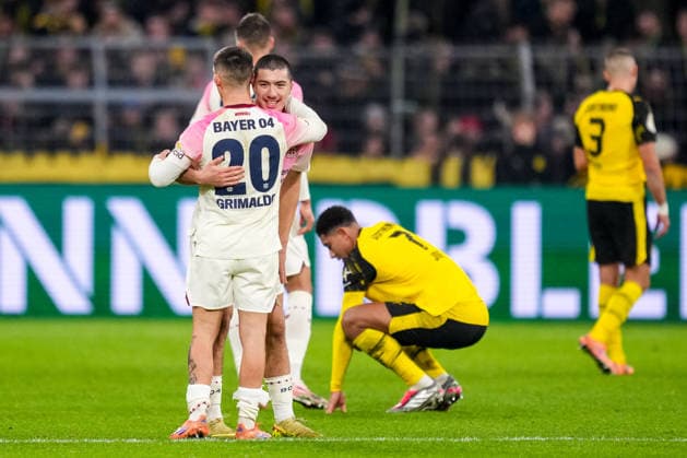 DORTMUND, GERMANY - DECEMBER 2: Alejandro Grimaldo of Bayer 04 Leverkusen and Ibrahim Maza of Bayer 04 Leverkusen celebrate their team s win while Jobe Bellingham of Borussia Dortmund looks dejected after the DFB Cup round of 16 match between Borussia Dortmund and Bayer 04 Leverkusen at Signal Iduna Park on December 2, 2025 in Dortmund, Germany. (Photo by Rene Nijhuis) SPO  Copyright: xRenexNijhuis
