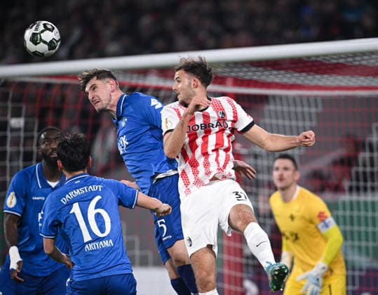 Fussball DFB Pokal Achtelfinale 2025 2026 03.12.2025 SC Freiburg - SV Darmstadt 98 Max Rosenfelder (re, SC Freiburg) gegen Matej Maglica (Mitte, SV Darmstadt 98) und Hiroki Akiyama (li, SV Darmstadt 98)