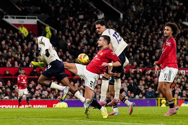 Manchester, England, 4th December 2025. Diogo Dalot of Manchester United, ManU can™t quite reach a cross during the Manchester United vs West Ham United Premier League match at Old Trafford, Manchester. Picture credit should read: Andrew Yates Sportimage EDITORIAL USE ONLY. No use with unauthorised audio, video, data, fixture lists, club league logos or live services. Online in-match use limited to 120 images, no video emulation. No use in betting, games or single club league player publications. SPI_032_AY_MANUTD_WESTHAM SPI-4345-0033