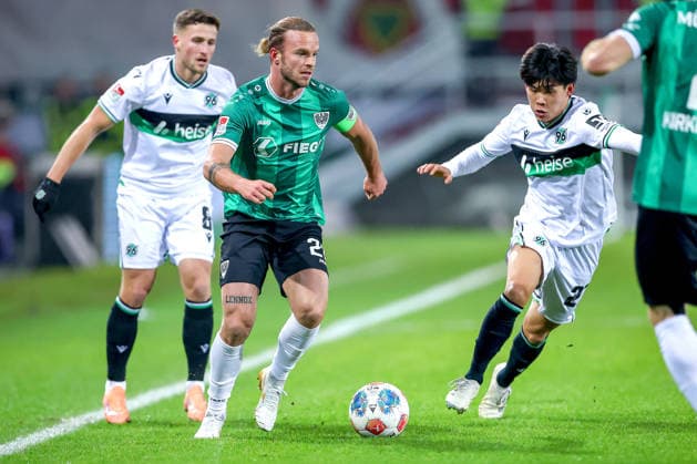 05.12.2025, Fußball, Preußen Münster - Hannover 96, 2. Fußball Bundesliga, Preußenstadion, Saison 2025 2026: Jorrit Hendrix (Preussen Muenster 20) im Zweikampf gegen Enzo Leopold (Hannover96 08) und Daisuke Yokota (Hannover96 18) DFB regulations prohibit any use of photographs as image sequences and or quasi-video. Nordrhein-Westfalen Deutschland
