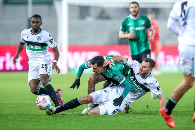 05.12.2025, Fußball, Preußen Münster - Hannover 96, 2. Fußball Bundesliga, Preußenstadion, Saison 2025 2026: Noel Aseko (Hannover96 15) Oliver Batista Meier (Preussen Muenster 17) im Zweikampf gegen Boris Tomiak (Hannover96 03) DFB regulations prohibit any use of photographs as image sequences and or quasi-video. Nordrhein-Westfalen Deutschland