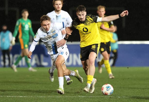 Samstag 06.12.2025, Saison 2025 26, Regionalliga West, 18. Spieltag im Stadion Rote Erde Dortmund, BVB Borussia Dortmund II - SC Paderborn U23, Julius Burgenhagen (SCP) gegen Tony Reitz (BVB II), v.l.