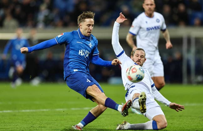 06.12.2025, Fussball 2. Bundesliga, SV Darmstadt 98 - Karlsruher SC, emonline, emspor, despor, v.l., Luca Marseiler (SV Darmstadt 98), Sebastian Jung (Karlsruher SC) DFL DFB REGULATIONS PROHIBIT ANY USE OF PHOTOGRAPHS AS IMAGE SEQUENCES AND OR QUASI-VIDEO. xdcx