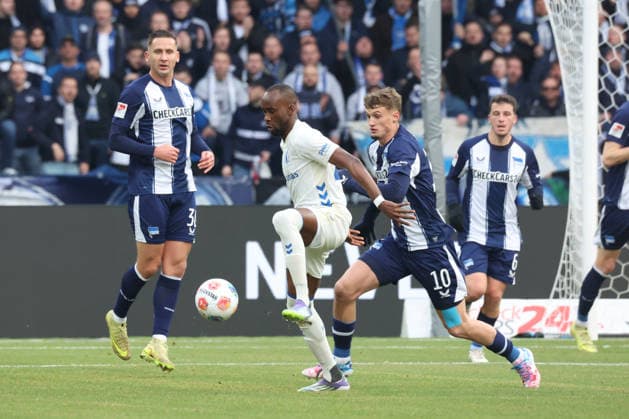 DEU, DFL, 2. FBL, Hertha BSC vs. 1: FC Magdeburg, 07.12.2025, Berliner Olympiastadion, Berlin, DEU, DFL, 2. FBL, Hertha BSC vs. 1: FC Magdeburg, im Bild Michael Cuisance (Hertha BSC Berlin 10), Paul Seguin (Hertha BSC Berlin 30), Silas Gnaka (1.FC Magdeburg 25) DFL - regulations prohibit any use of Photographs as image sequences and or quasi-video