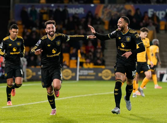 Wolverhampton, England, 8th December 2025. Bruno Fernandes of Manchester United, ManU (l) celebrates scoring the first goal with Matheus Cunha of Manchester United (r) during the Wolverhampton Wanderers vs Manchester United Premier League match at Molineux, Wolverhampton. Picture credit should read: Andrew Yates Sportimage EDITORIAL USE ONLY. No use with unauthorised audio, video, data, fixture lists, club league logos or live services. Online in-match use limited to 120 images, no video emulation. No use in betting, games or single club league player publications. SPI_054_AY_Wolves_Man_Utd SPI-4356-0054