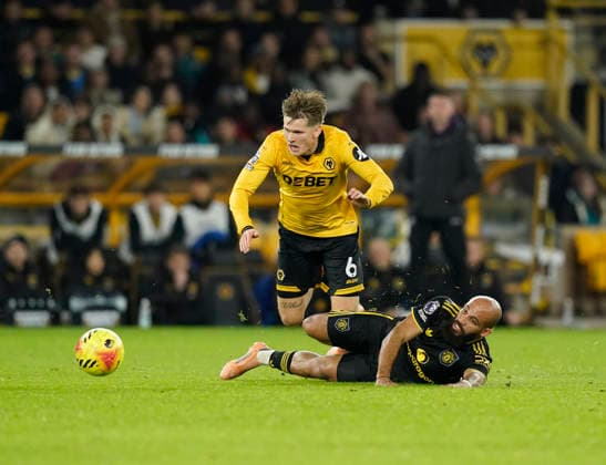 Wolverhampton, England, 8th December 2025. Bryan Mbeumo of Manchester United, ManU tussles with David Moller Wolfe of Wolverhampton Wanderers during the Wolverhampton Wanderers vs Manchester United Premier League match at Molineux, Wolverhampton. Picture credit should read: Andrew Yates Sportimage EDITORIAL USE ONLY. No use with unauthorised audio, video, data, fixture lists, club league logos or live services. Online in-match use limited to 120 images, no video emulation. No use in betting, games or single club league player publications. SPI_062_AY_Wolves_Man_Utd SPI-4356-0064