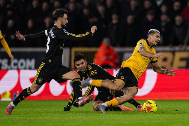 8th December 2025; Molineux Stadium, Wolverhampton, West Midlands, England; Premier League Football, Wolverhampton Wanderers versus Manchester United, ManU Andre of Wolverhampton Wanderers is brought down by Casemiro of Manchester United Editorial use only: DataCo restrictions apply See www.football-dataco.com  GodfreyxPitt