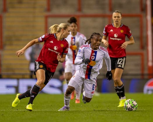 10th December 2025; Leigh Sports Village, Manchester, England; Womens Champions League Football, Manchester United, ManU versus Lyon Women; Melchie Dumornay of OL Lyonnes under pressure from Lisa Naalsund of Manchester United Women  TimxWilliams