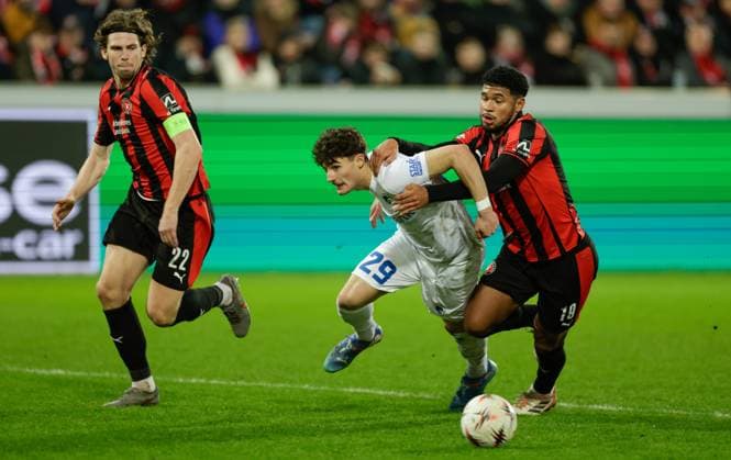 Genk s Robin Mirisola and Midtjylland s Pedro Bravo fight for the ball during a soccer game between Danish FC Midtjylland and Belgian KRC Genk, on Thursday 11 December 2025 in Herning, Denmark, on the sixth game (out of 8) in the league phase of the UEFA Europa League competition. LEONxGONZALES  x148236487x