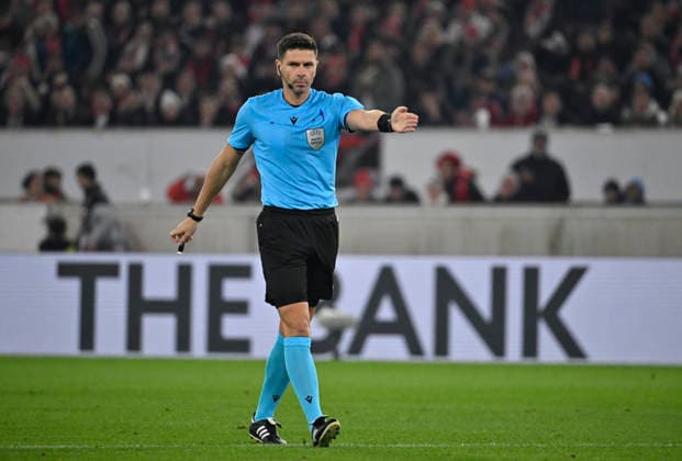 Schiedsrichter Referee Marian Barbu (ROU) pfeift Elfmeter, Strafstoss Gestik Geste im Hintergrund Bandenwerbung Logo THE BANK VfB Stuttgart vs Maccabi Tel-Aviv FC EUROPA LEAGUE EL 11.12.2025 DFL REGULATIONS PROHIBIT ANY USE OF PHOTOGRAPHS AS IMAGE SEQUENCES AND OR QUASI-VIDEO VfB Stuttgart vs Maccabi Tel-Aviv FC EUROPA LEAGUE EL