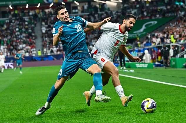 Jordan v Iraq : FIFA Arab Cup 2025 Ali Olwan of Jordan and Zaid Ismael of Iraq in action during the FIFA Arab Cup 2025 Quarter-final match between Jordan and Iraq at Education City Stadium in Doha, Qatar, on December 12, 2025. DOHA Qatar Copyright: xNOUSHADxTHEKKAYILx